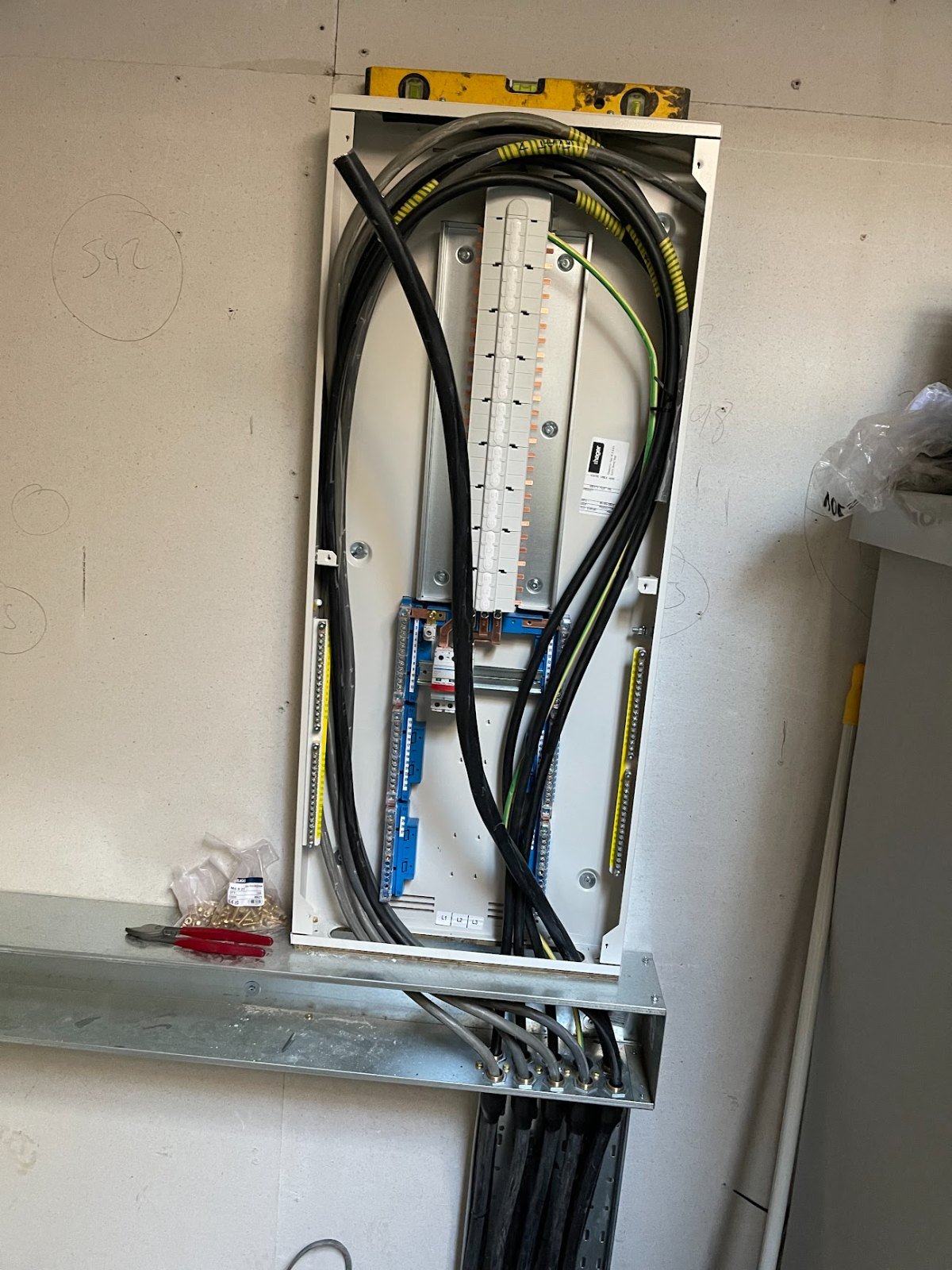 Large distribution board being installed with cable tray and busbar, levelled and ready for termination